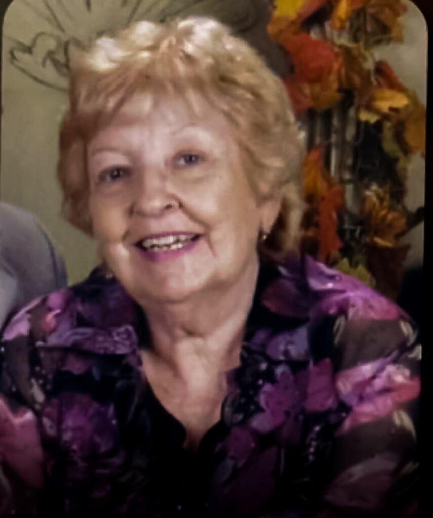 Picture of Darlene Schnur Smiling in a floral pink and black blouse
